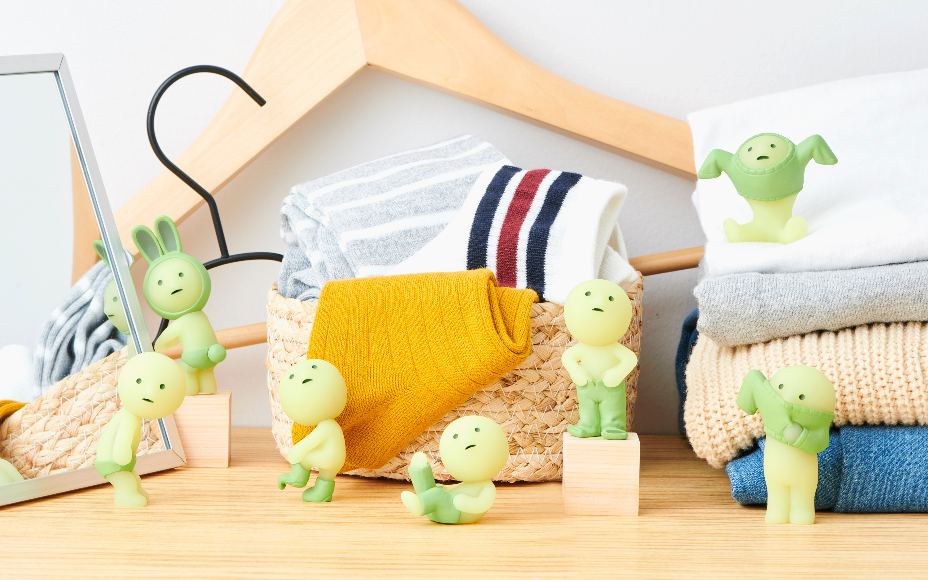 smiski dressing series full figure lineup on a wooden backdrop with laundry-themed props