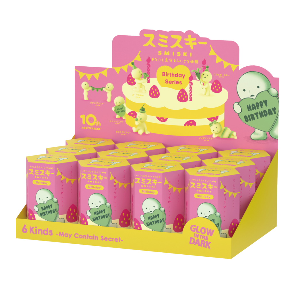SMISKI Birthday Series product packaging shows SMISKI holding a heart with "Happy Birthday" in the center. Pink and yellow box shows strawberries and birthday candles with yellow text that states "SMISKI" and "Birthday". Text on product display also states "6 Kinds- May Contain Secret-" and "Glow in the dark"
